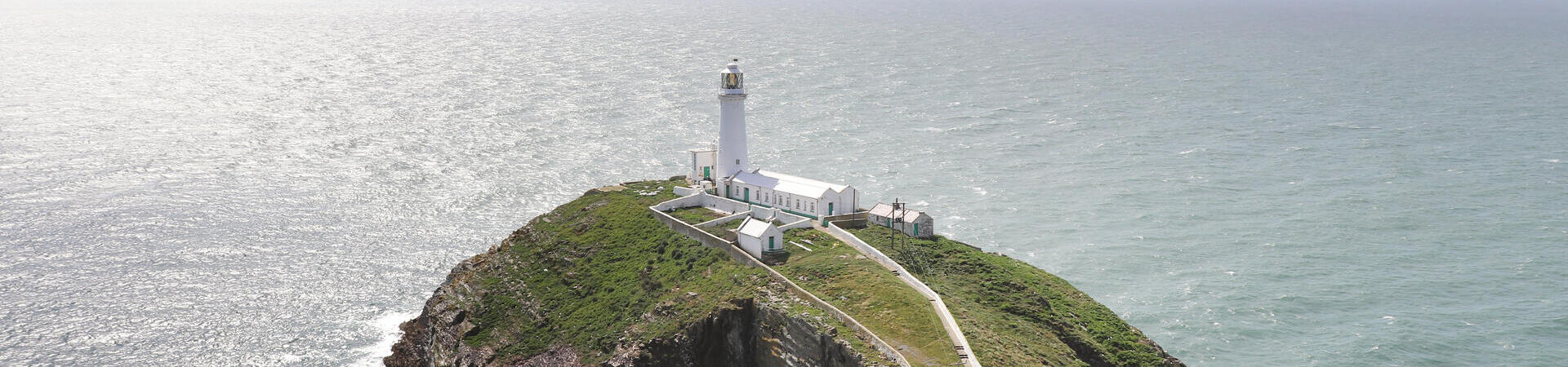 A lighthouse at the end of a peninsula