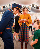 Character actors talking to a young child.