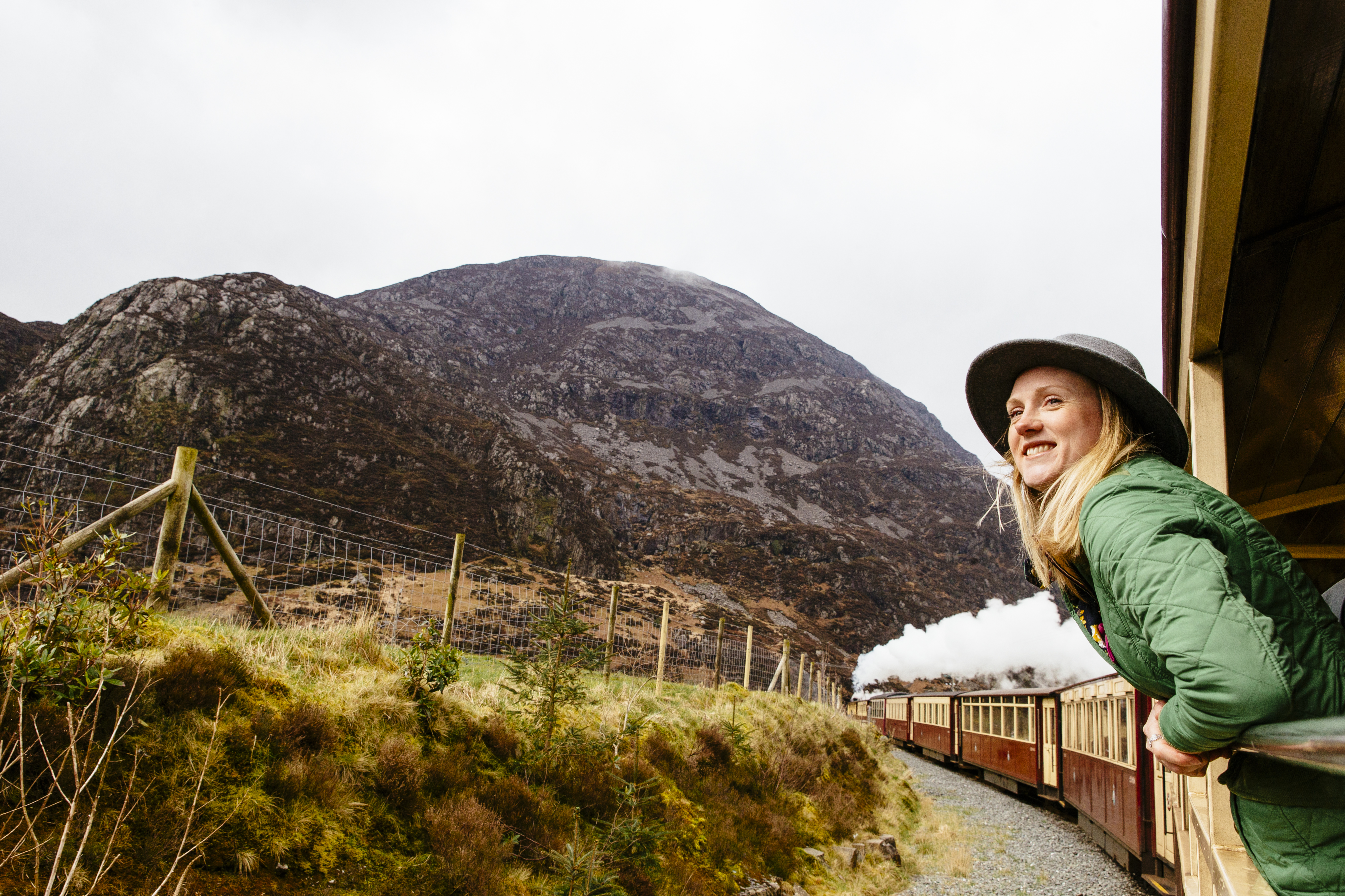 Woman leaning out of window of steam train