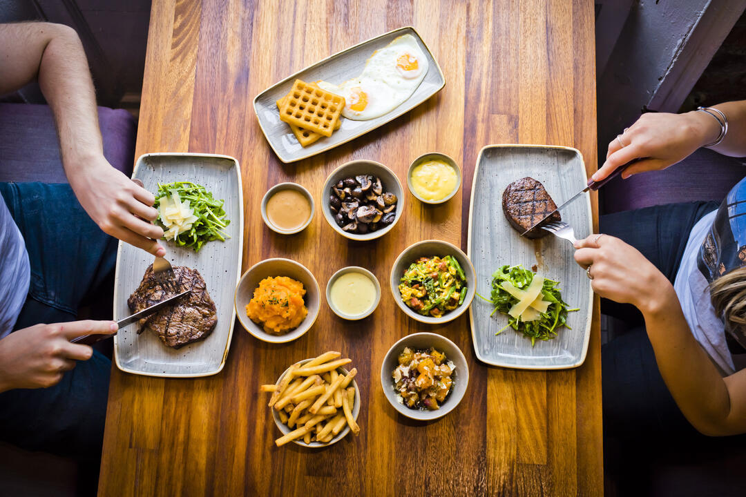 Two people eating steaks at Liverpool's Cowshed Restaurant