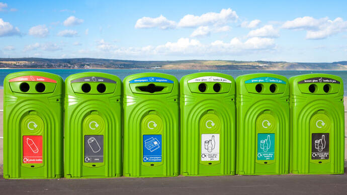 Row of recycling bins overlooking the coast