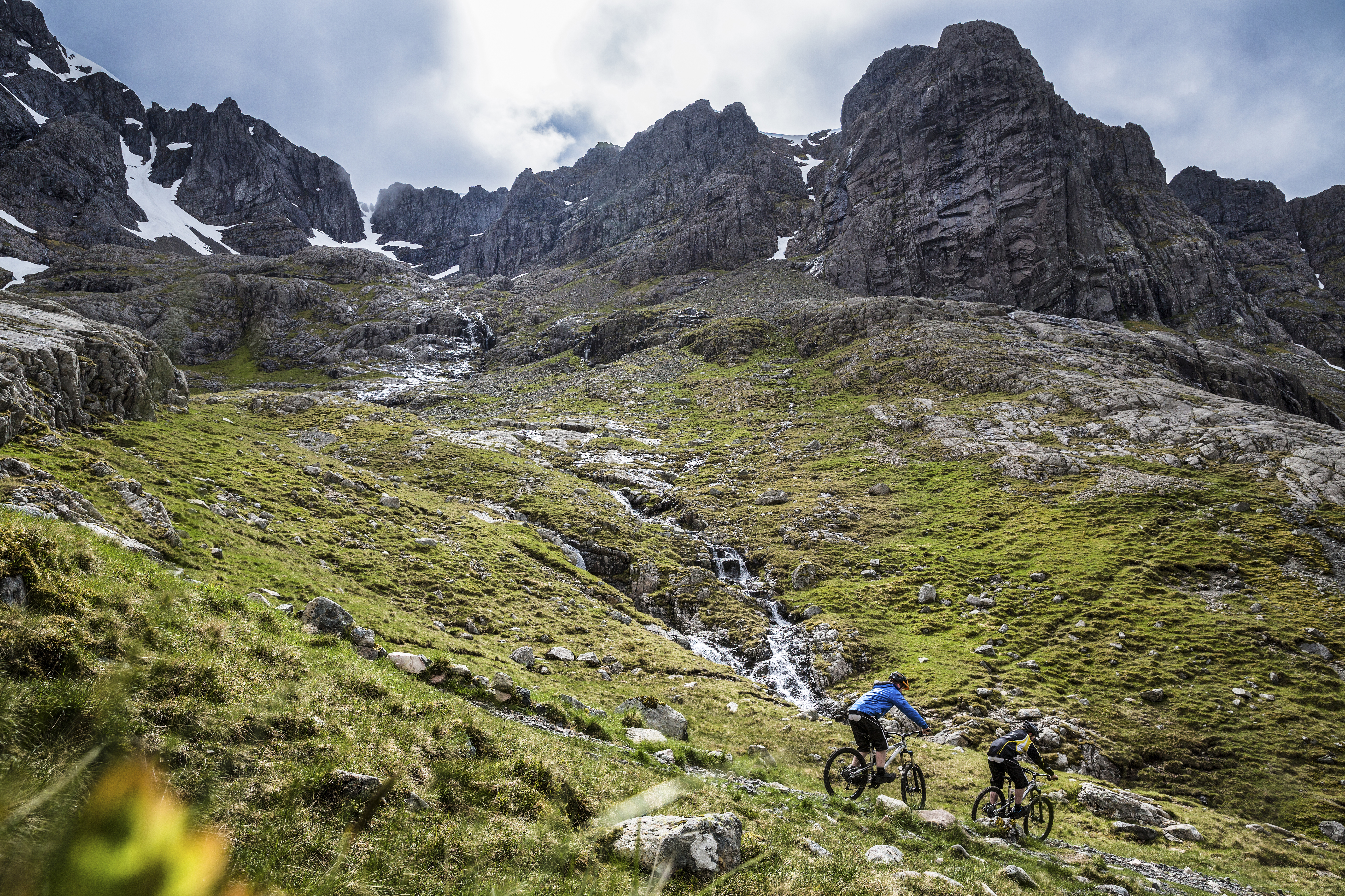 Two mountain bikers cycling down a mountain
