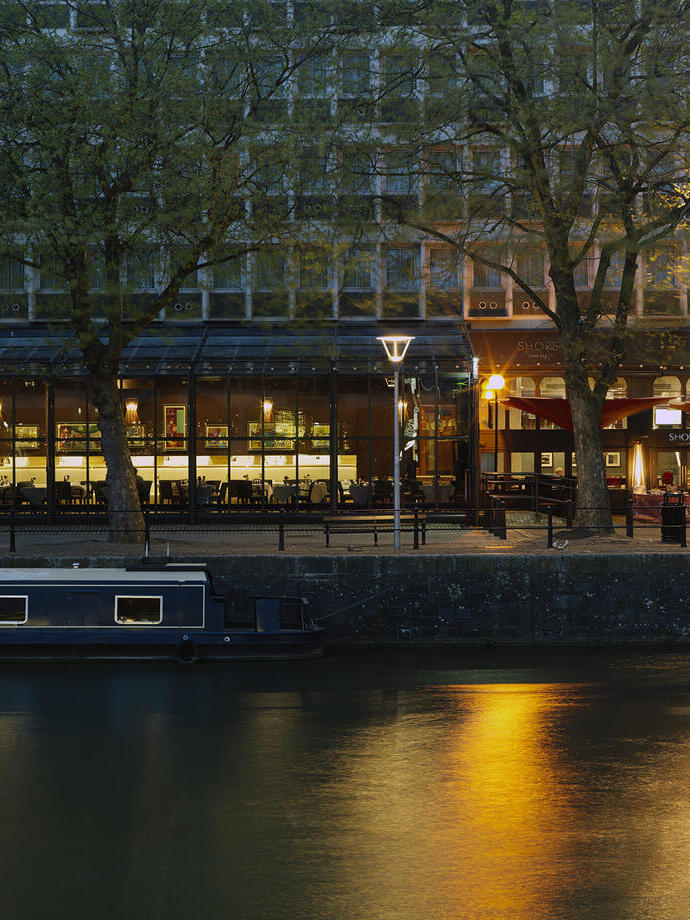 Exterior of a hotel from the city harbourside at night.