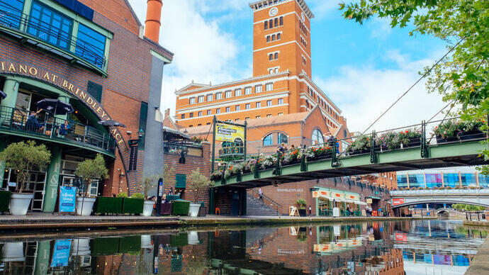 Bridges across a canal. One bridge line with flower beds