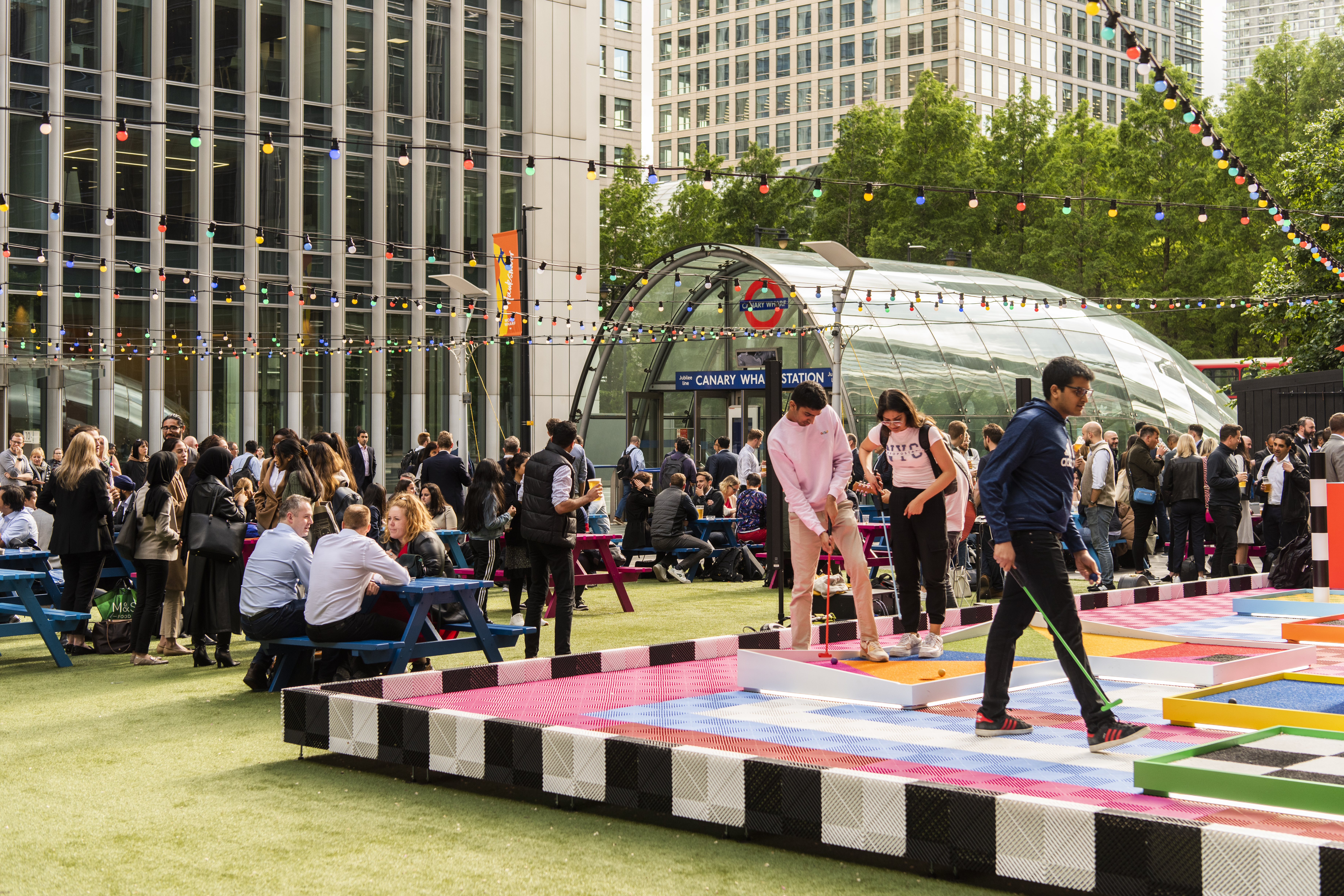 People playing mini golf at the Night Market in Canary Wharf