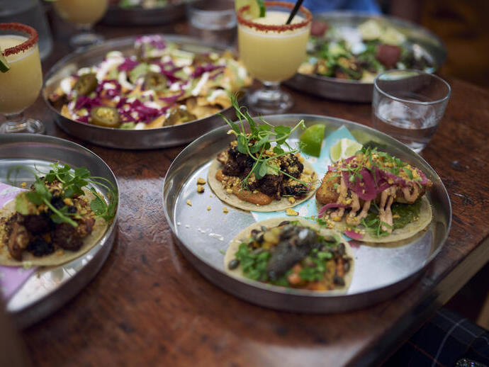 Plates of food on a table in a restaurant at a food court