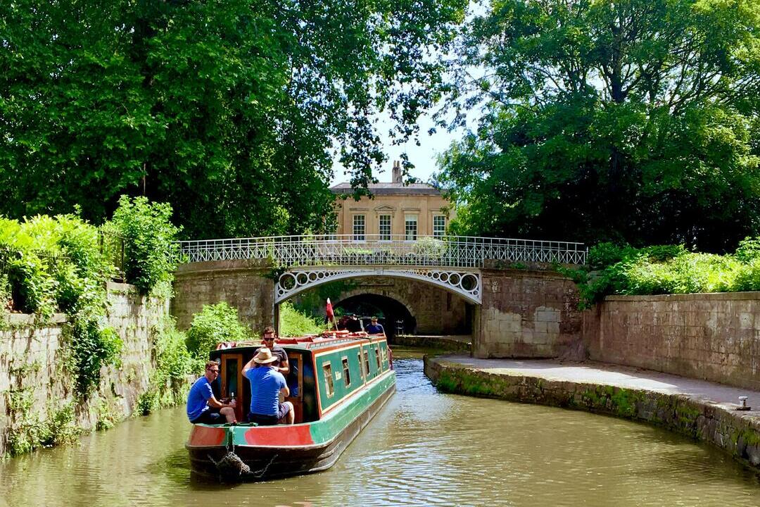 A barge sailing down a canal in Bath