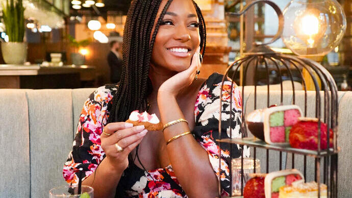 Young woman smiling and sitting at a restaurant table