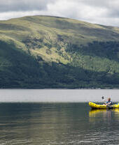 Person kayaking on a lake