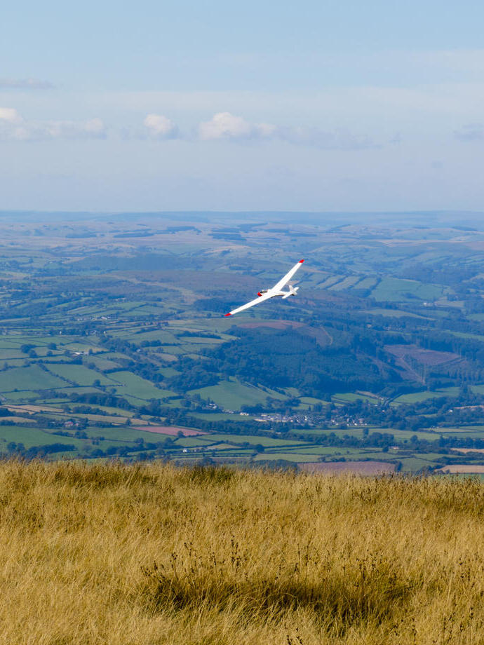 Un planeador sobrevolando los campos rurales locales.