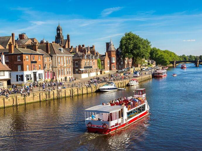 A cruise ship travelling down the River Ouse in York