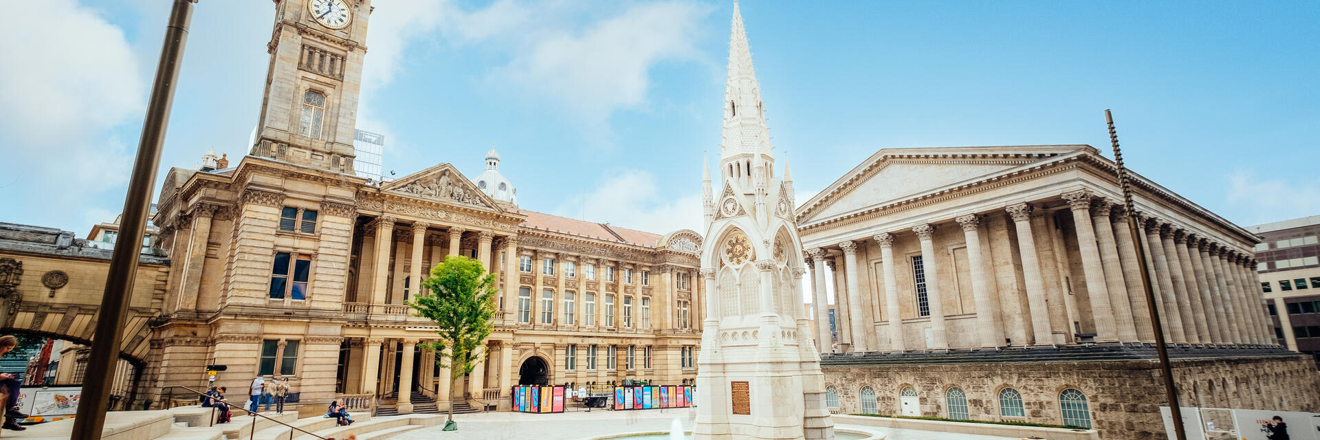 Historical building, with a clock tower, beside a fountain