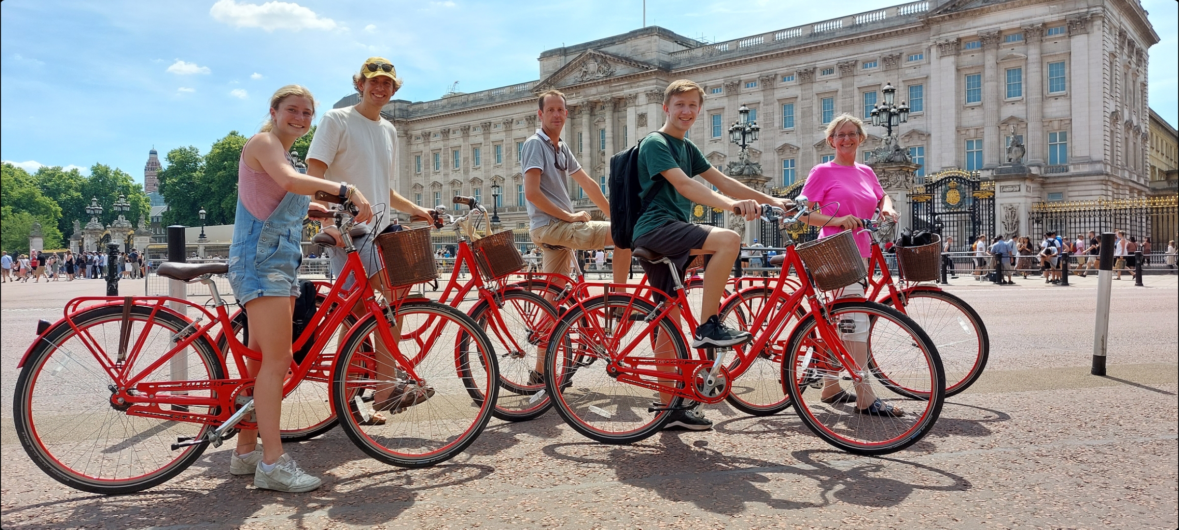 Group of people on bicycles on an Old London Tour in front of Buckingham Palace