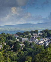 The skyline of quaint countryside village and rolling hills in the background.