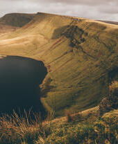 A reservoir surrounded by hills in a countryside landscape.