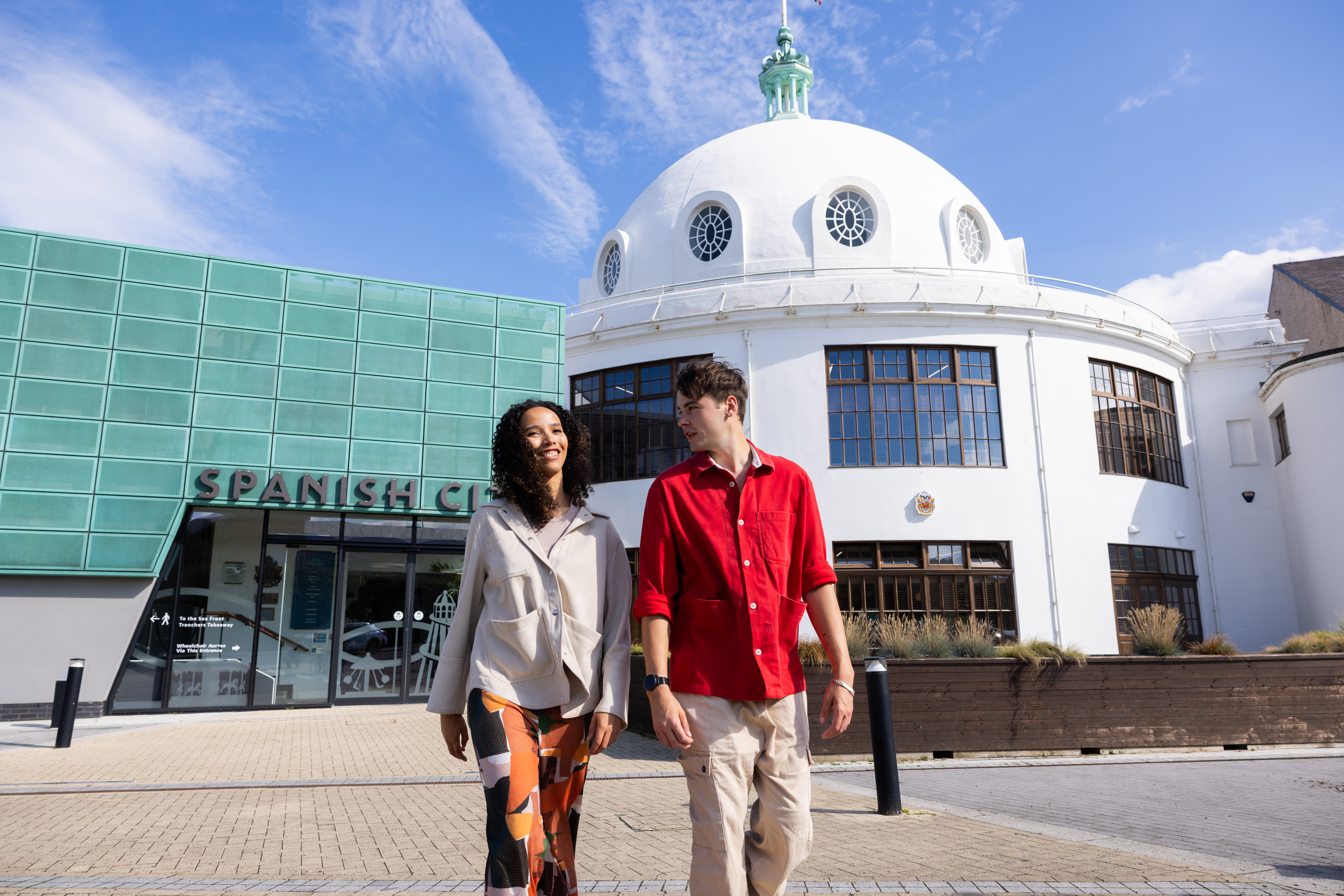 Two friends visiting an old art deco seaside building.