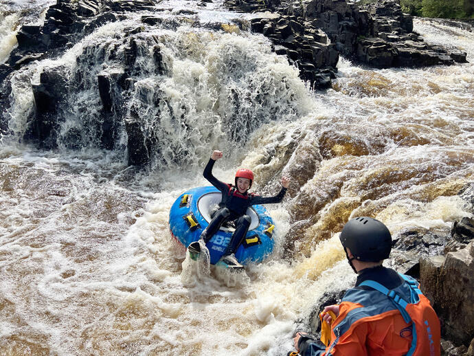 A woman rafting down some rapids at Endless Adventure North East in Newcastle