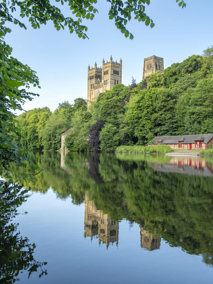 A view of a river with a Cathedral beyond