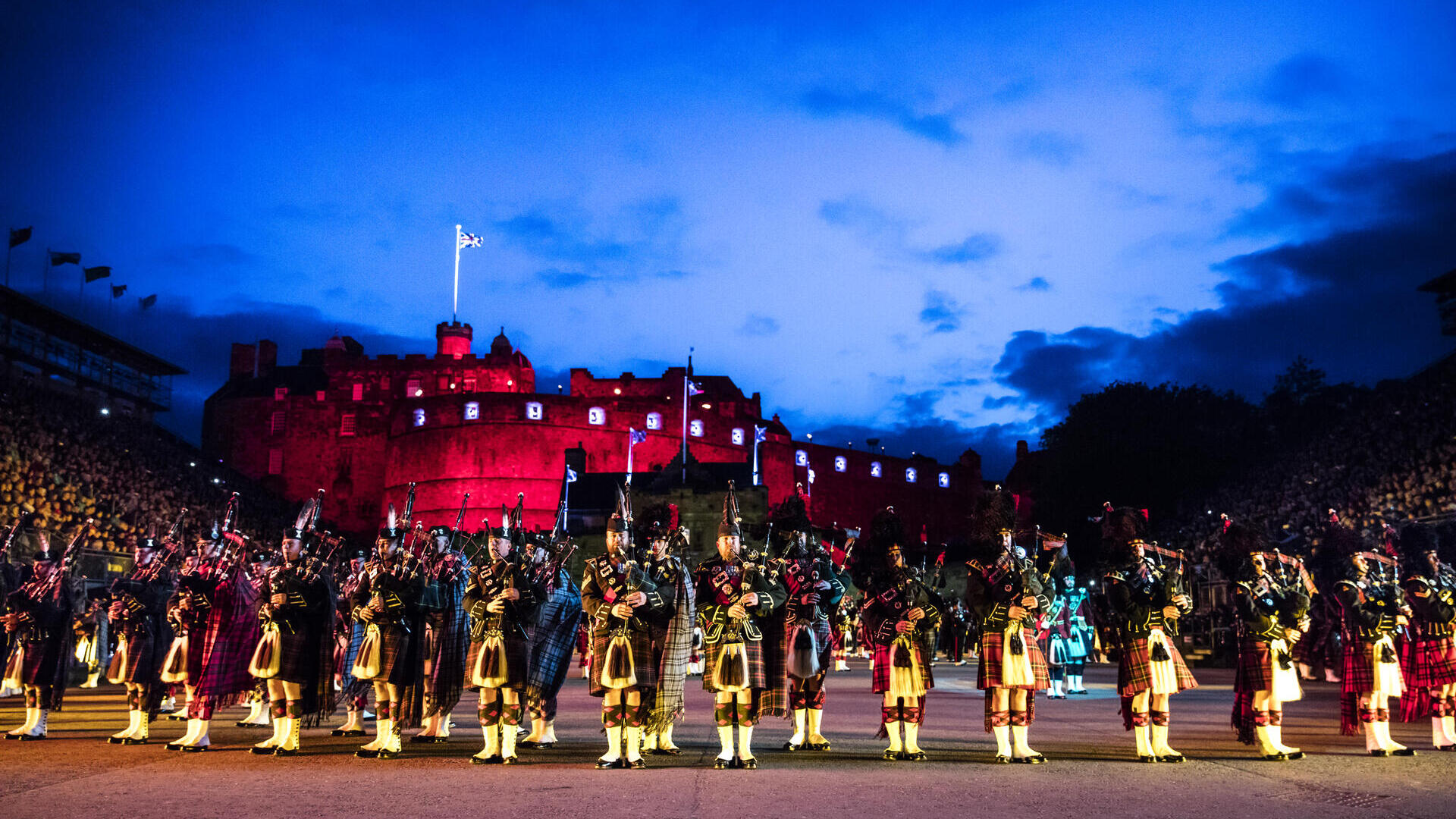 Marching band and light show projecting onto the castle