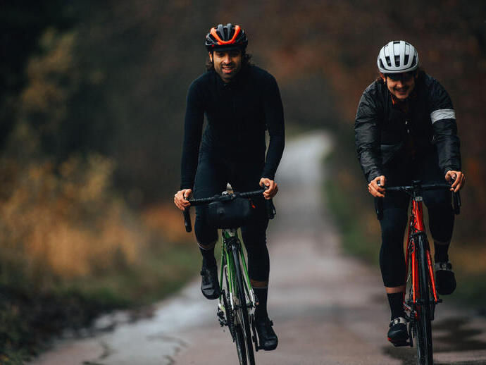 Two cyclists riding on a road