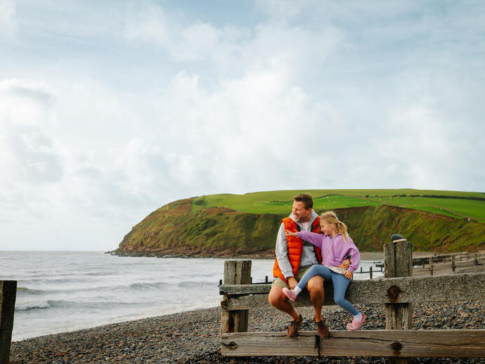 Father and daughter having fun on a beach