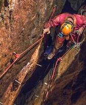 A man exploring through a cave system at Cornwall Underground Adventures