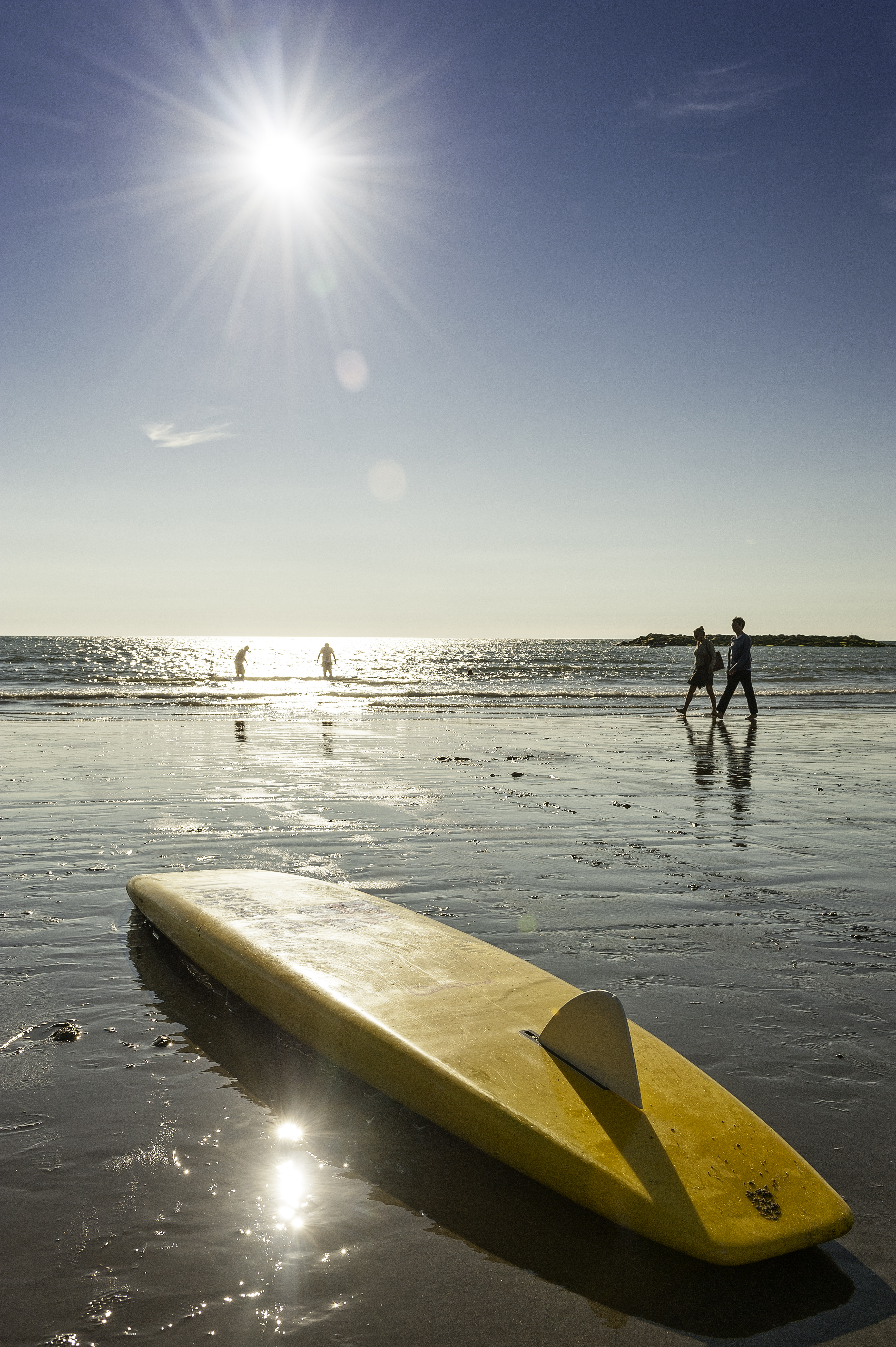 A surfboard in the sun on Borth Beach in Wales