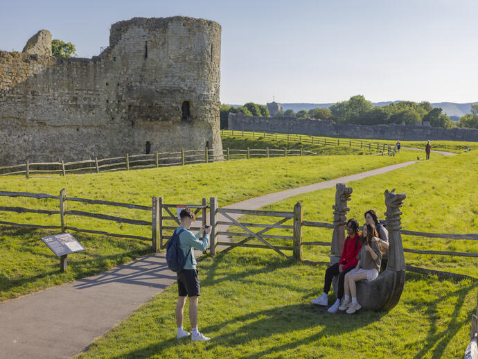 A group of friends visit castle ruins in the summer