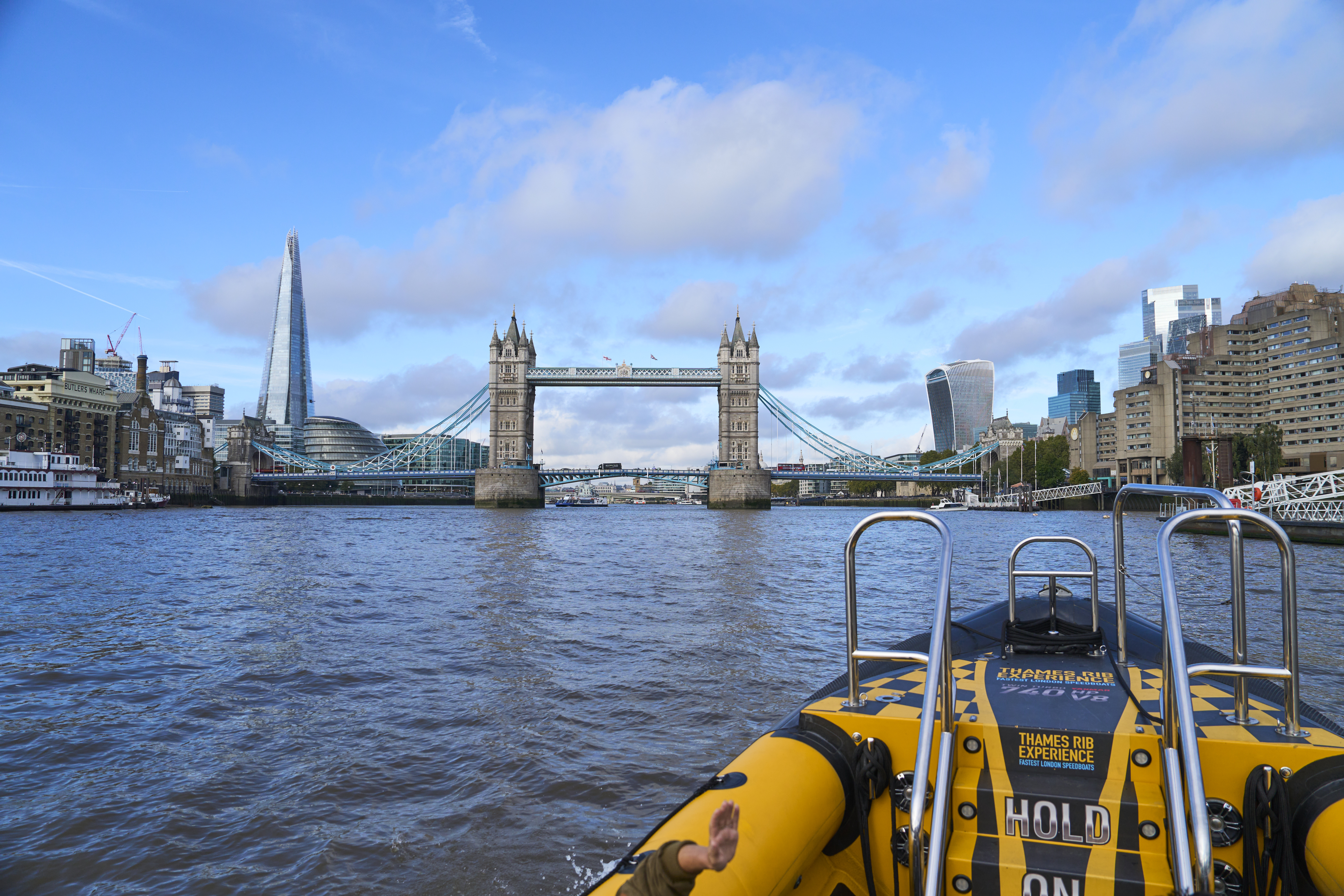 Group of people on board a speed boat on a city river