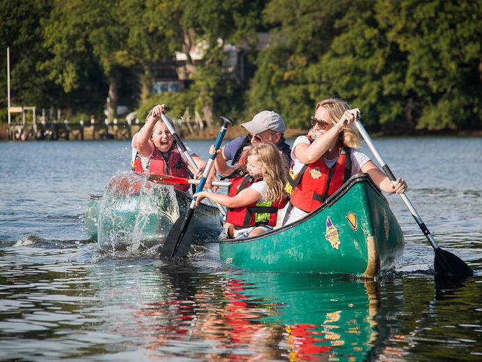 Family with children canoeing on a river