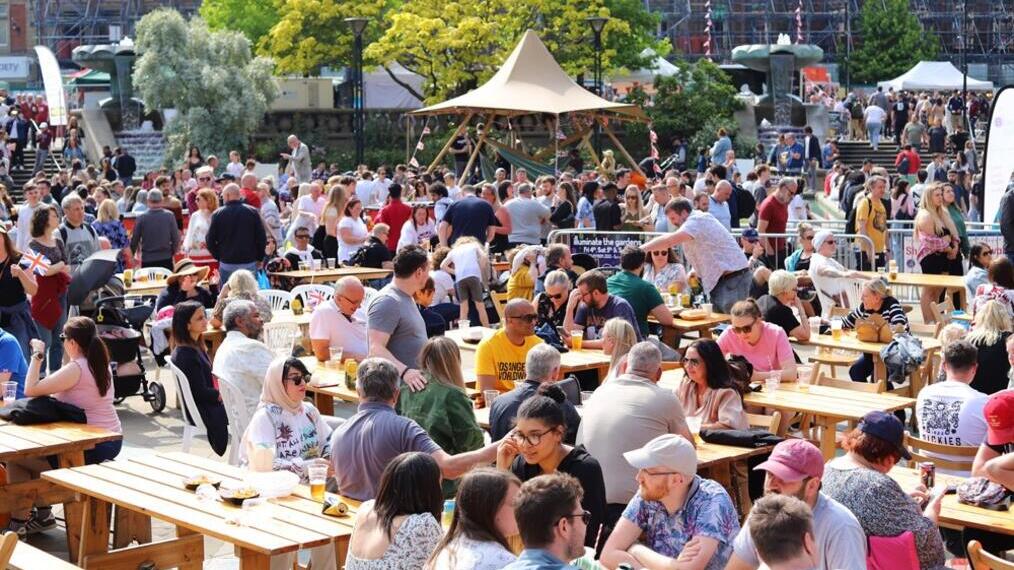 Crowds of people eating and drinking outside as part of Sheffield Food Festival