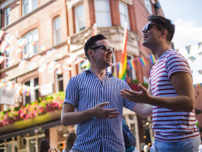 Young men talk outside a bar
