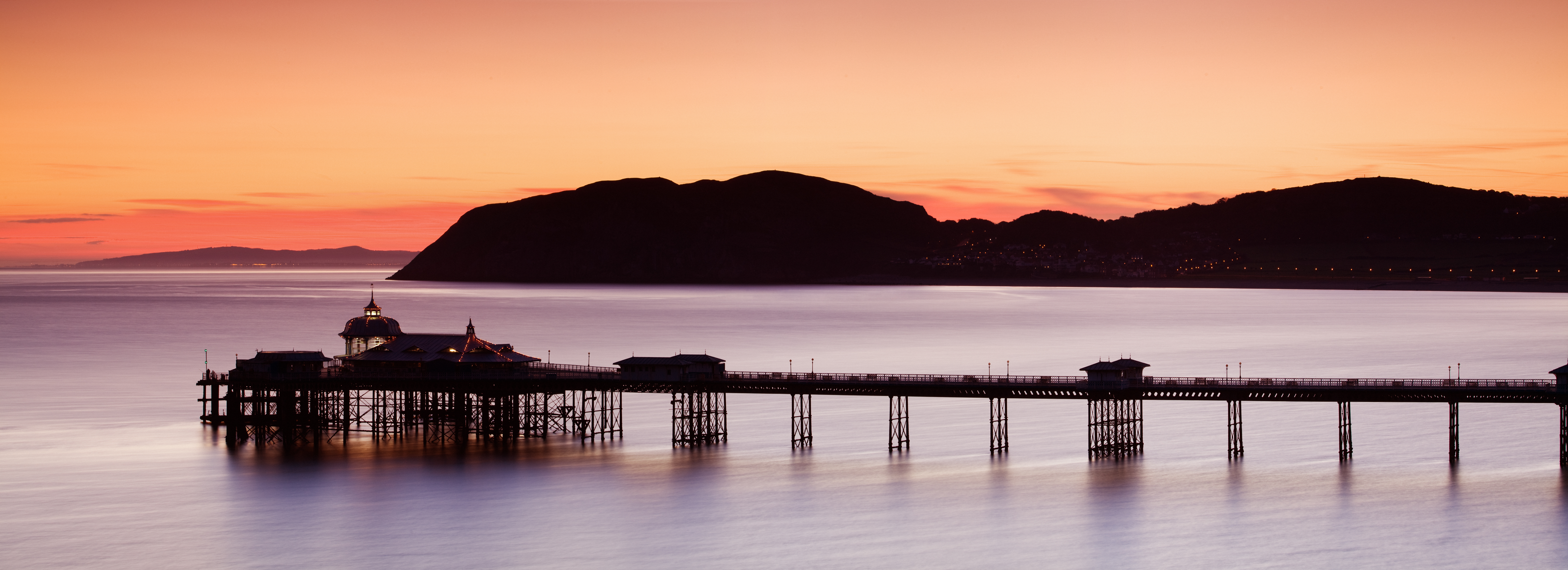 Pier built out into the sea in grand Edwardian style at dusk