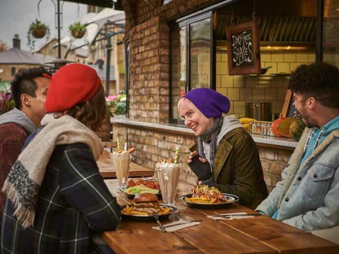 Friends eating a meal outside a restaurant