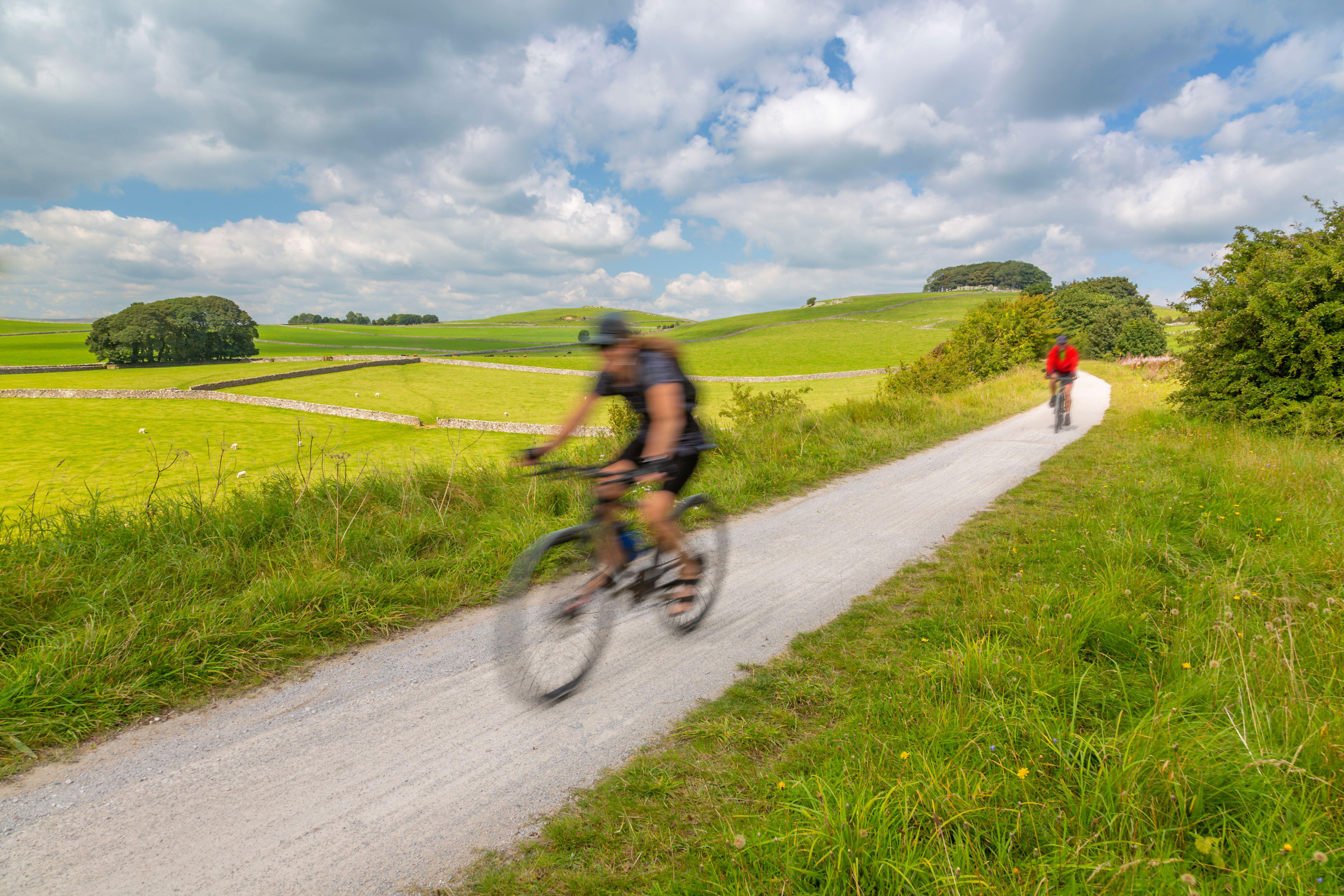 Two cyclists on a trail in the countryside