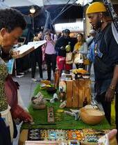 Lady looking at a stall display at Portobello Vegan Night Market
