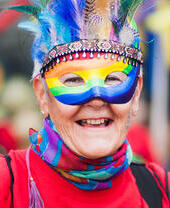 Close up of person with a rainbow mask, smiling