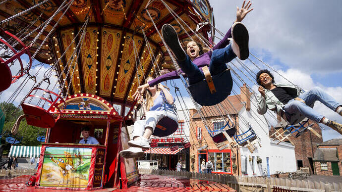 A family have fun on a fairground ride at Black Country Living Museum, VisitEngland Awards for Excellence 2025 Gold Winner.