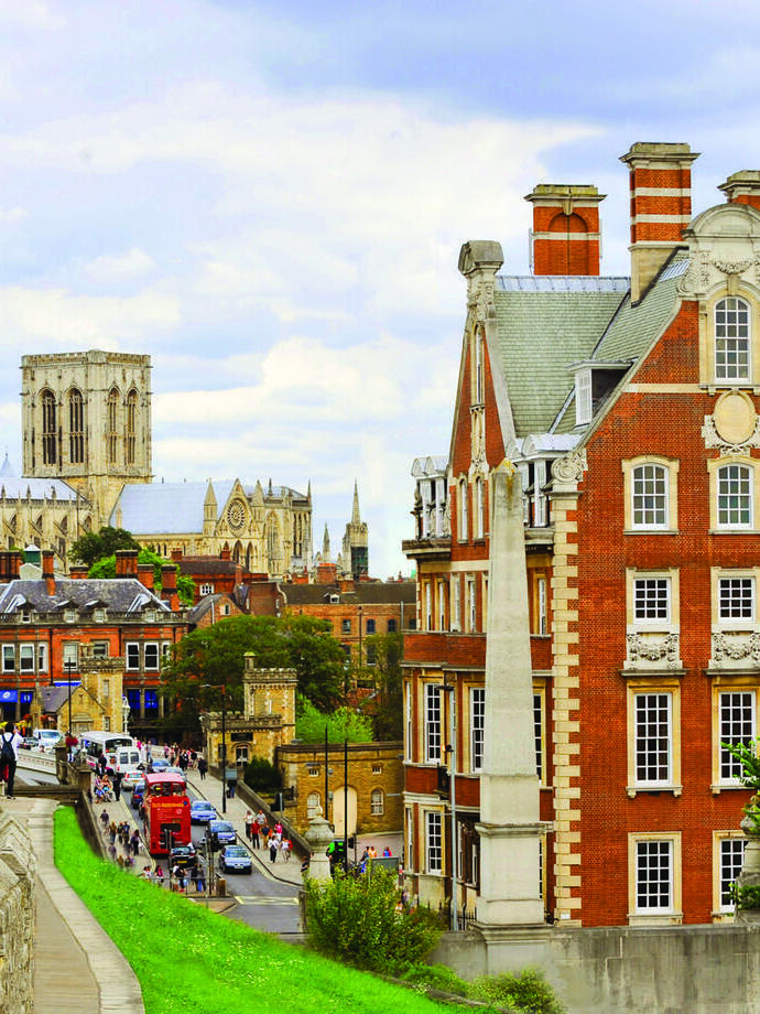 View of the red brick exterior of The Grand Hotel York with the city wall 