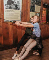 Two children playing with an exhibit at the National Emergency Services Museum in Sheffield