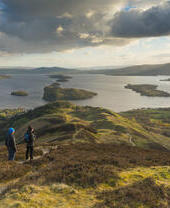 Walkers taking in the view of Loch Lomond from Conic Hill part of the West Highland Way