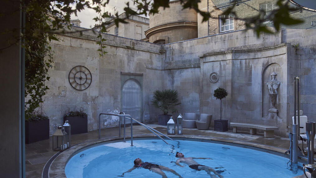 Couple in an open air thermal pool at a spa