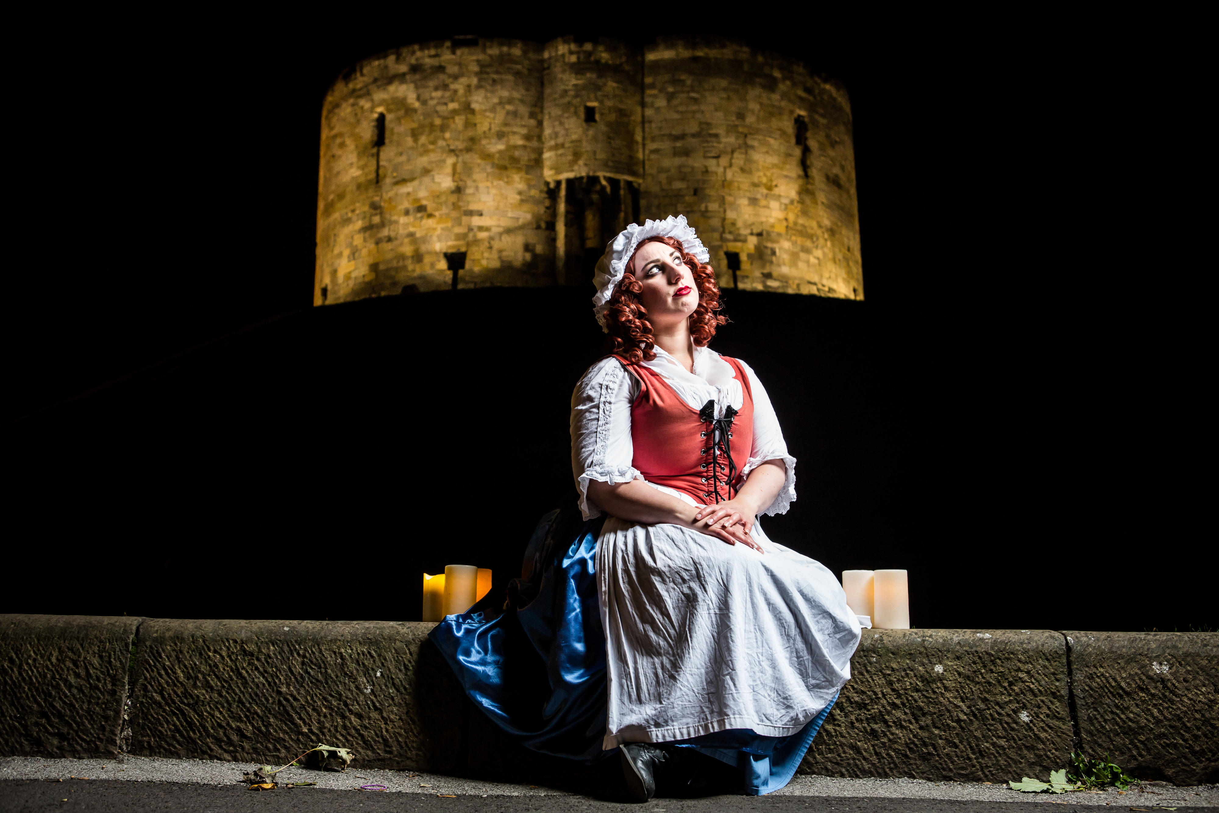A performer in costume outside Cliffords Tower in York