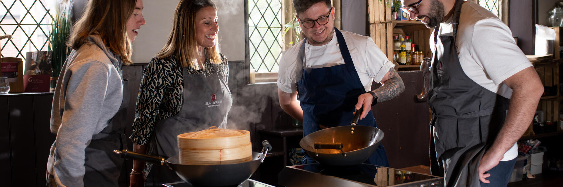 A group of people watch a cooking demonstration