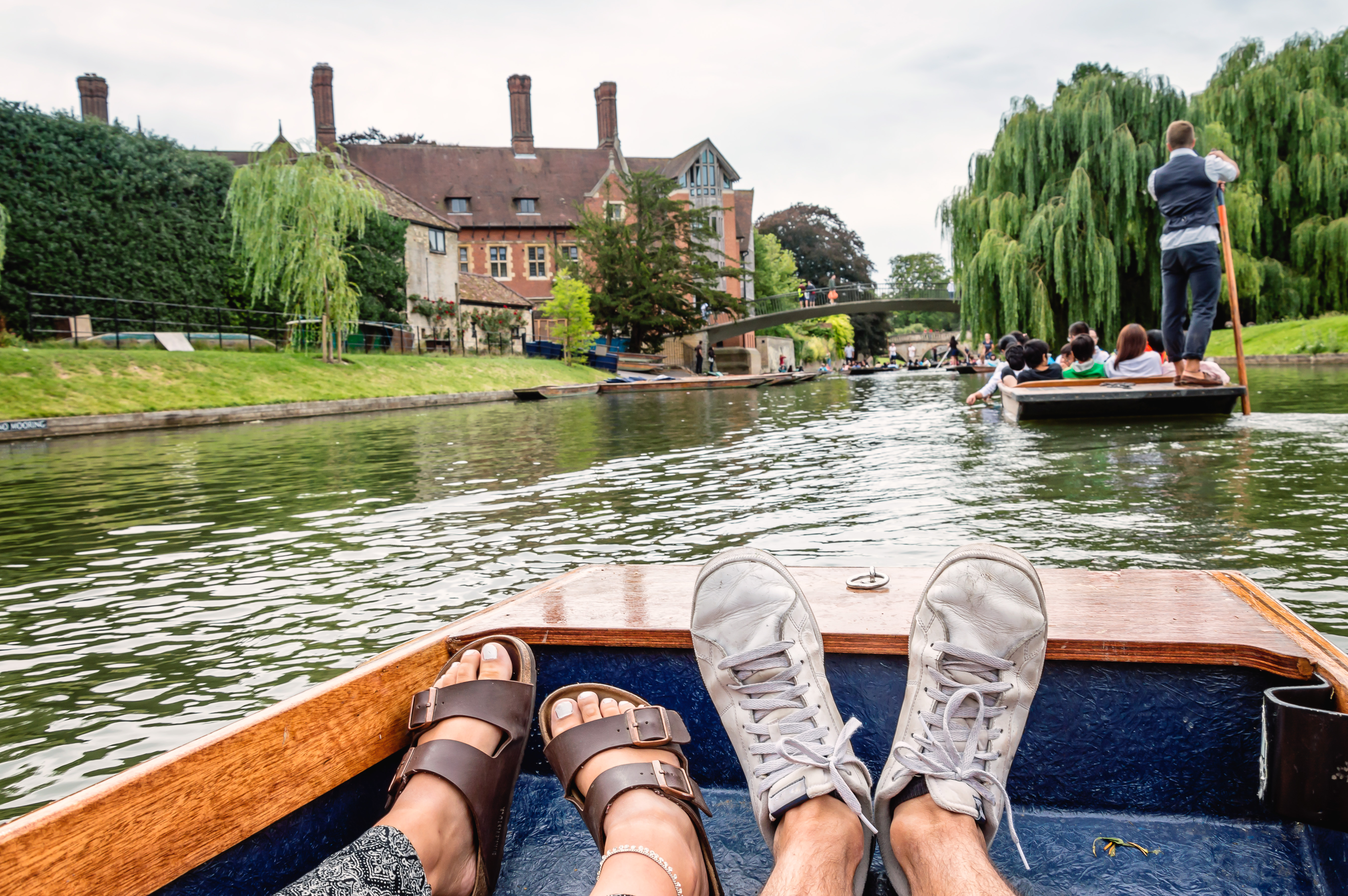 Two feet inside a boat; punting on a river