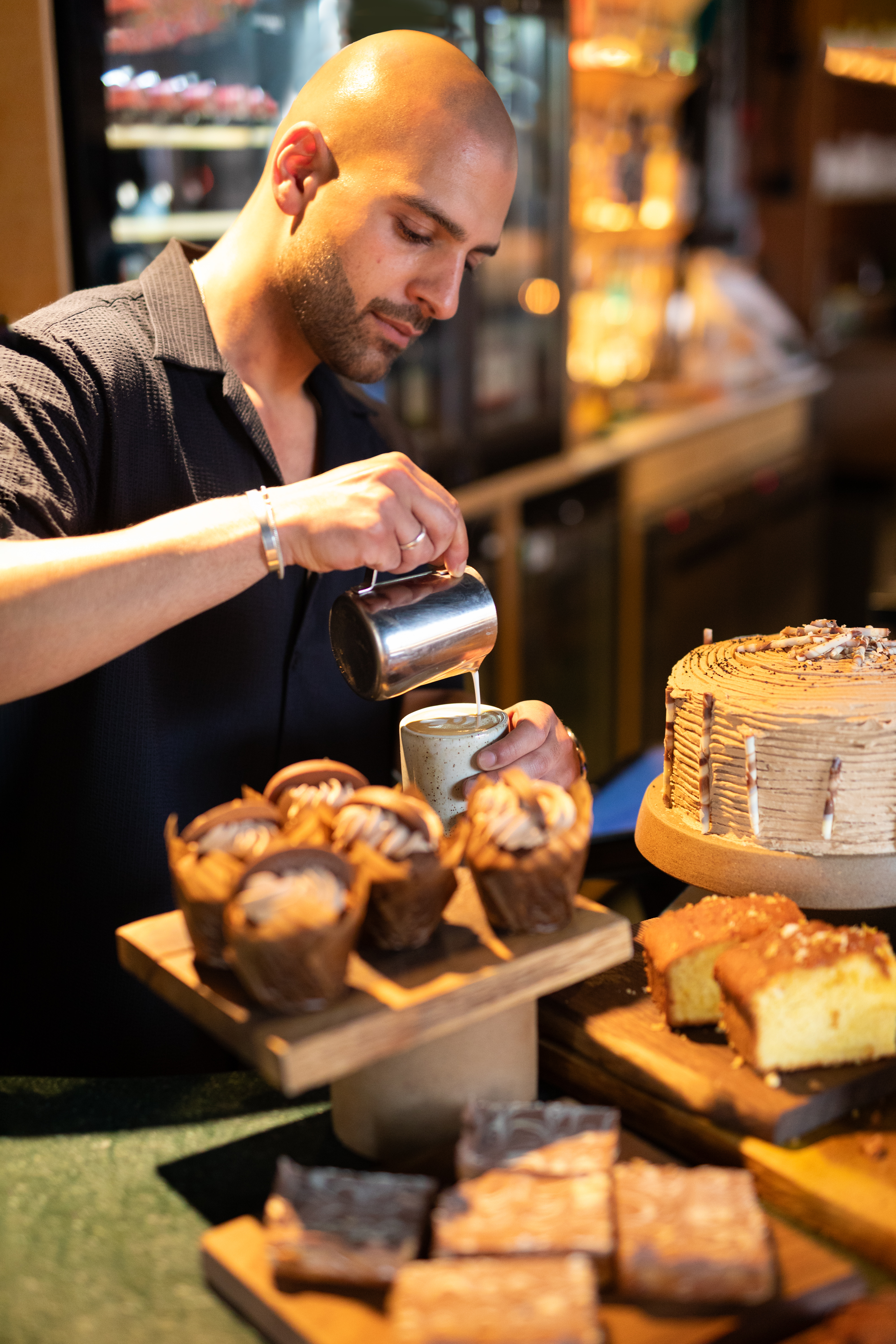 A Barista makes coffee at in a local cafe.