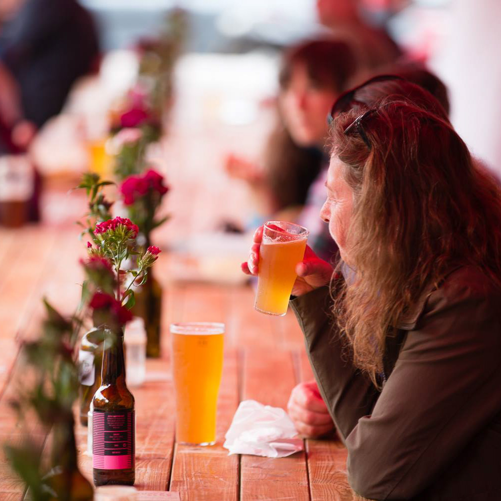 People sitting outside at table drinking beer