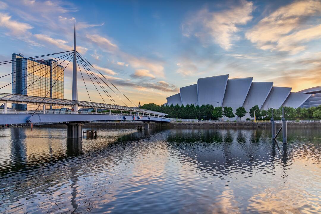 Modern building next to a river and a bridge
