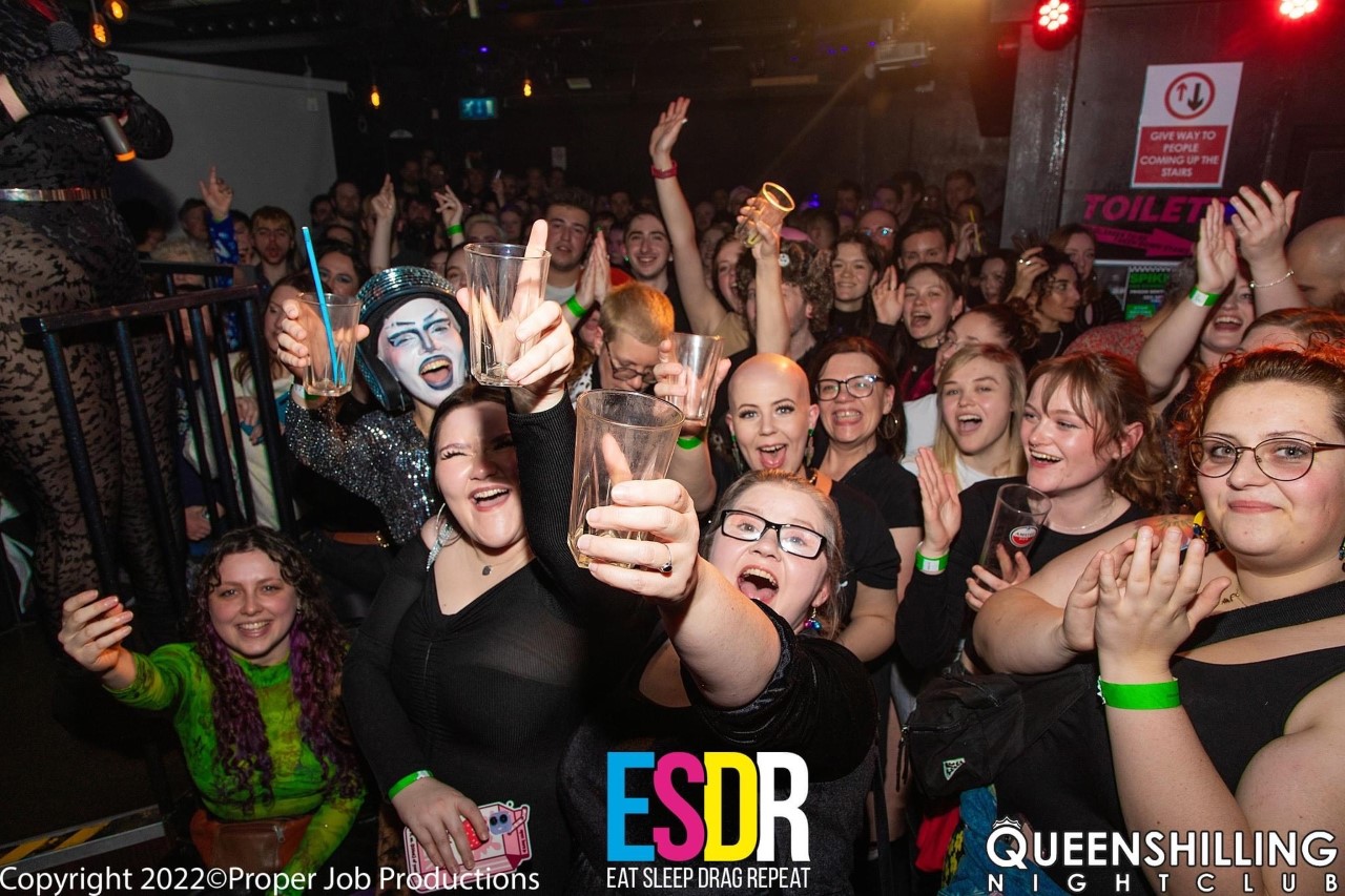 A group of people posing during a club night at Queenshilling in Bristol