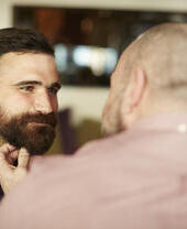 Closeup of two gay men being affectionate